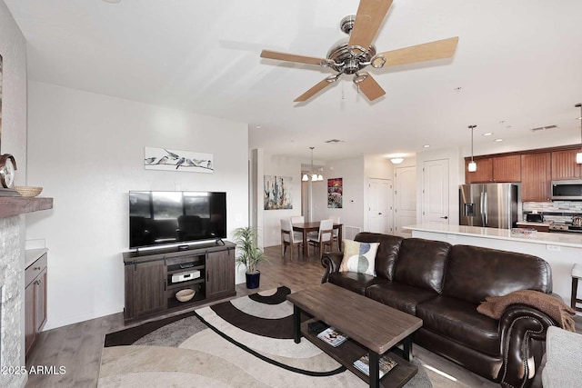 living room featuring light hardwood / wood-style flooring and ceiling fan