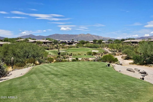 surrounding community featuring a mountain view and a yard