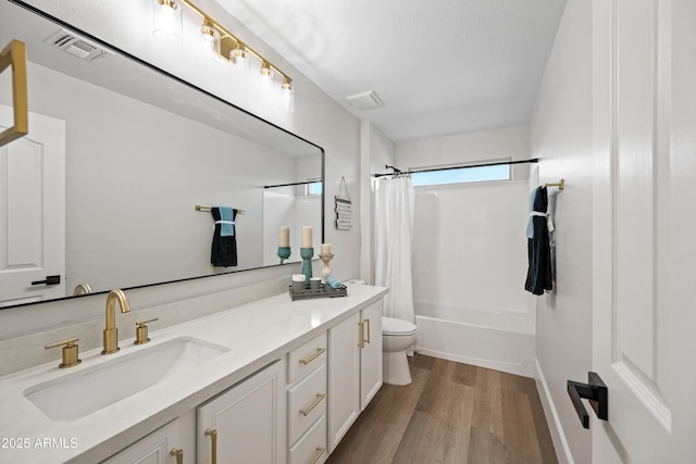 bathroom with shower / bath combination with curtain, visible vents, toilet, vanity, and wood finished floors