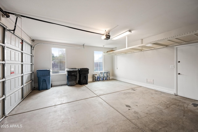 garage with baseboards and a garage door opener