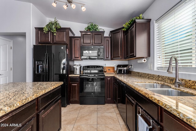 kitchen with sink, vaulted ceiling, black appliances, dark brown cabinetry, and light tile patterned floors