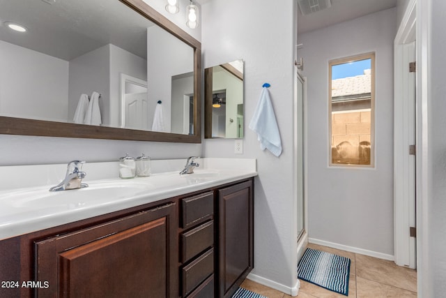 bathroom featuring walk in shower, vanity, and tile patterned floors