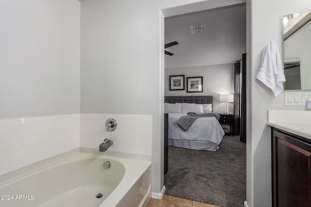 bathroom featuring vanity, a bathing tub, and tile patterned flooring