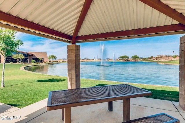 surrounding community with a water view, a gazebo, and a yard