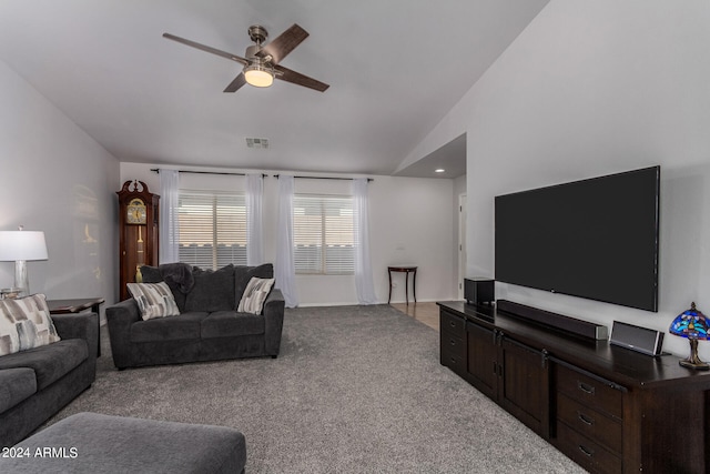 carpeted living room with lofted ceiling and ceiling fan