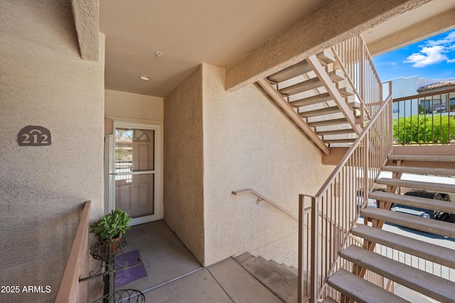 entrance to property featuring stucco siding
