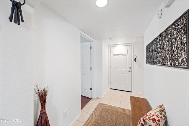 corridor with tile patterned floors and baseboards