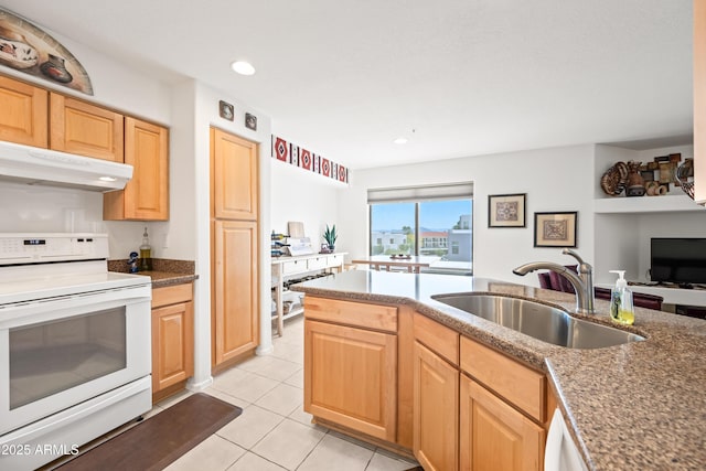 kitchen featuring light tile patterned flooring, light brown cabinets, under cabinet range hood, white range with electric stovetop, and a sink
