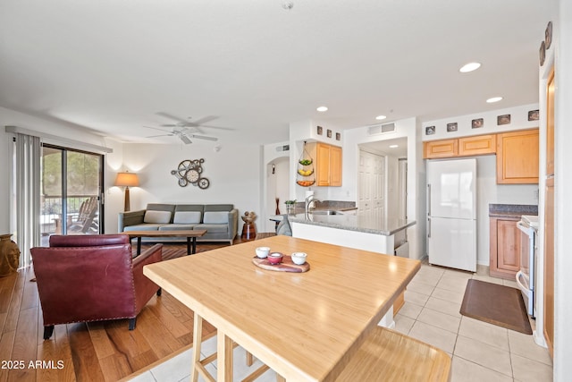 dining space with visible vents, recessed lighting, arched walkways, a ceiling fan, and light tile patterned floors
