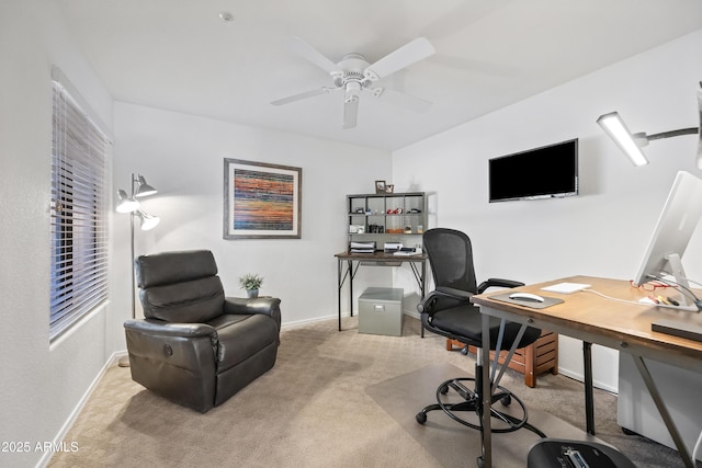 carpeted home office with a ceiling fan and baseboards