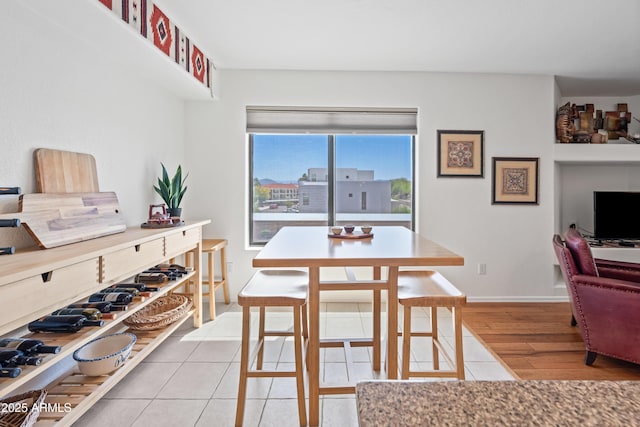 dining area with baseboards and light tile patterned floors