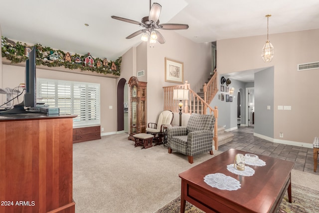 living room with carpet floors, high vaulted ceiling, and ceiling fan