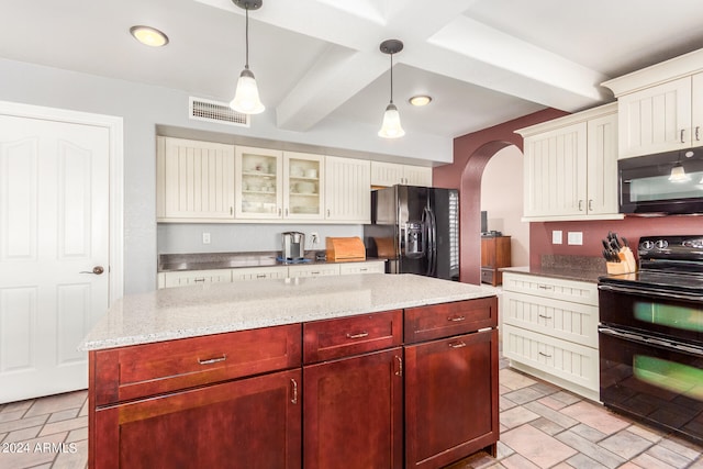 kitchen featuring beam ceiling, hanging light fixtures, light stone counters, black appliances, and a center island