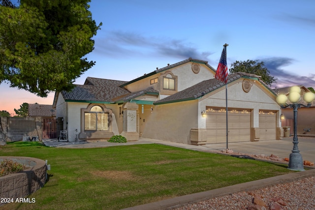 view of front of house featuring fence, an attached garage, stucco siding, a yard, and driveway