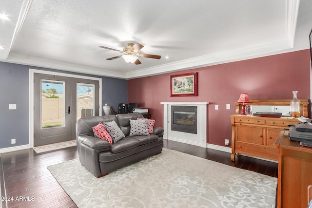living area with baseboards, ceiling fan, wood-type flooring, and french doors