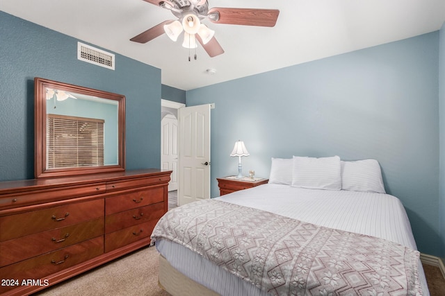 bedroom featuring a ceiling fan, baseboards, light colored carpet, and visible vents