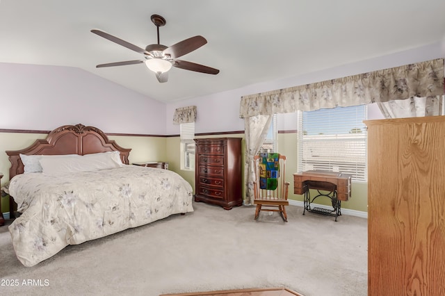 carpeted bedroom with a ceiling fan, baseboards, and lofted ceiling