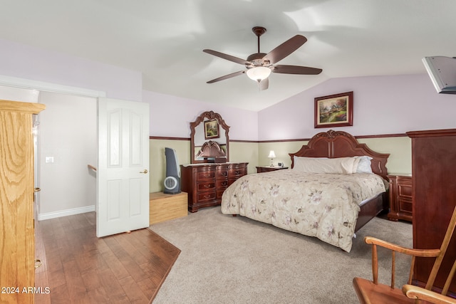 bedroom with hardwood / wood-style floors, ceiling fan, and vaulted ceiling