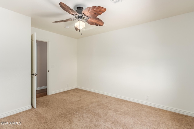 empty room with ceiling fan and light colored carpet