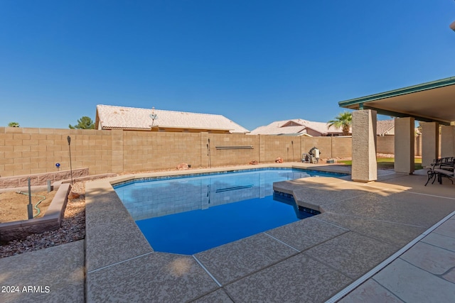 view of pool with a fenced in pool, a fenced backyard, and a patio area