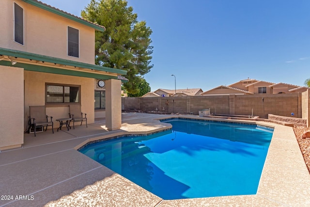 view of pool featuring a fenced backyard, a fenced in pool, and a patio