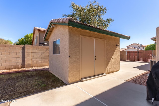 view of shed with fence