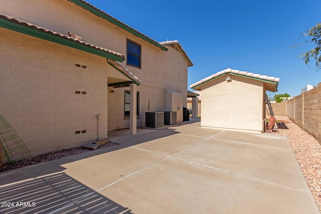 view of patio with cooling unit and a fenced backyard