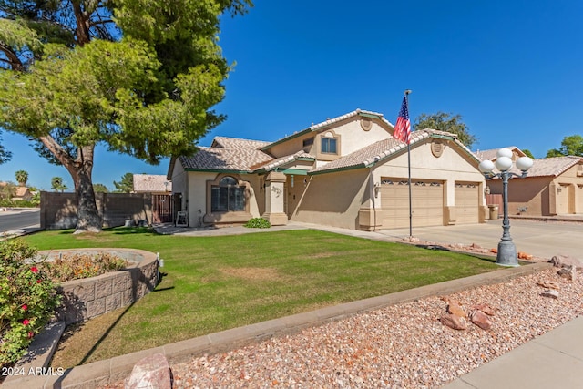 mediterranean / spanish-style house with a garage, a front lawn, fence, stucco siding, and concrete driveway