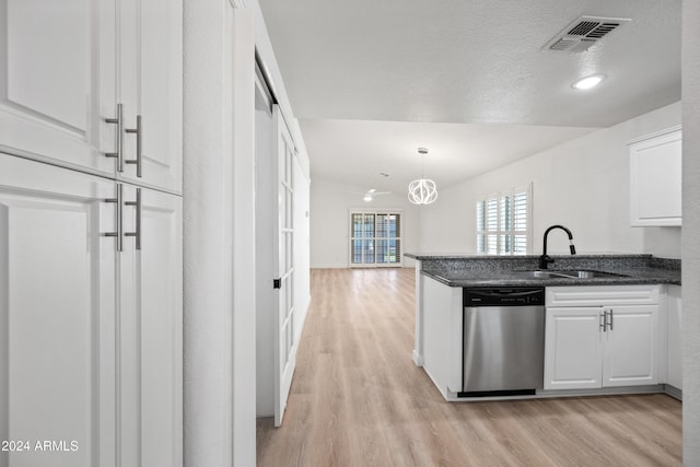 kitchen featuring sink, stainless steel dishwasher, pendant lighting, light hardwood / wood-style floors, and white cabinets