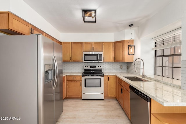 4901 E Kelton Ln Unit 1251, Scottsdale, AZ 85254 - kitchen featuring stainless steel appliances, decorative backsplash, light wood finished floors, light stone counters, and brown cabinets