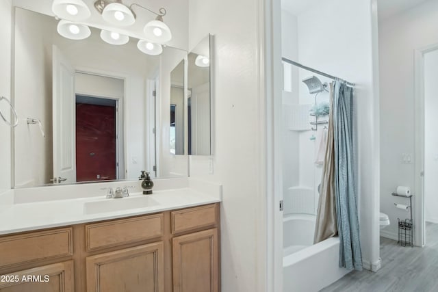 full bathroom with hardwood / wood-style flooring, vanity, shower / tub combo with curtain, and toilet