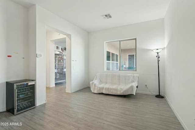 sitting room featuring hardwood / wood-style flooring and beverage cooler