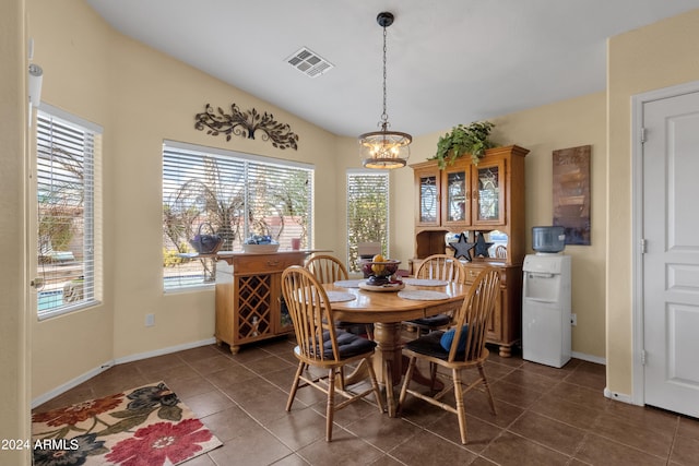 tiled dining space with a chandelier