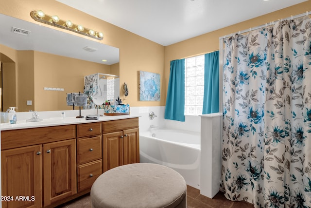 bathroom with plus walk in shower, tile patterned floors, and vanity