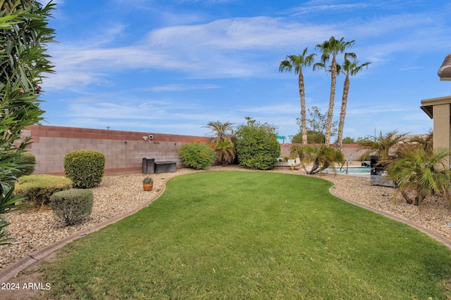 view of yard with a fenced in pool