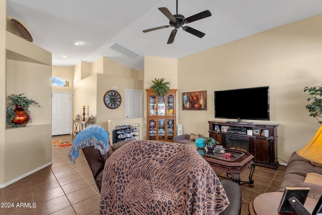 tiled living room featuring ceiling fan and high vaulted ceiling