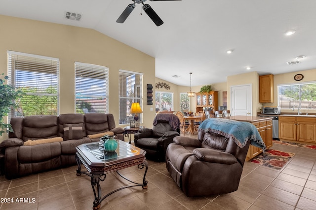 tiled living room with lofted ceiling, ceiling fan, and sink