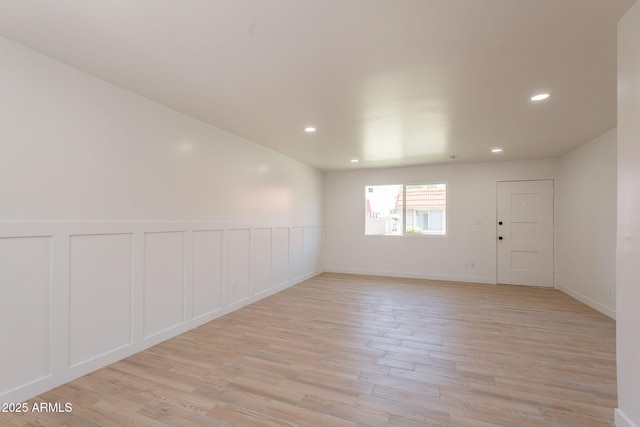 5132 N 83rd St, Scottsdale, AZ 85250 - empty room with light wood-style floors, recessed lighting, wainscoting, and a decorative wall