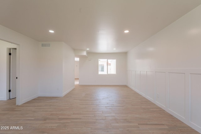 5132 N 83rd St, Scottsdale, AZ 85250 - unfurnished room with light wood finished floors, recessed lighting, a decorative wall, and a wainscoted wall
