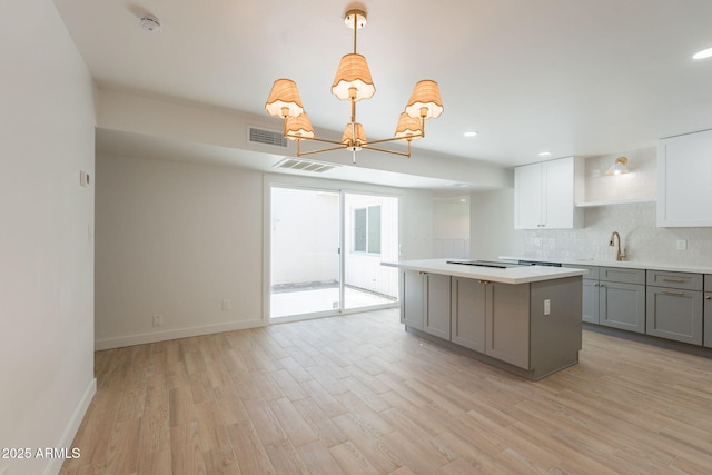 5132 N 83rd St, Scottsdale, AZ 85250 - kitchen with gray cabinets, open shelves, a sink, a center island, and light countertops