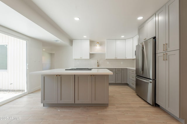 5132 N 83rd St, Scottsdale, AZ 85250 - kitchen featuring freestanding refrigerator, gray cabinetry, open shelves, a center island, and light countertops