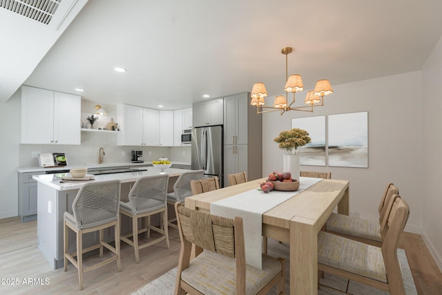 5132 N 83rd St, Scottsdale, AZ 85250 - dining room with a chandelier, light wood-style flooring, and recessed lighting