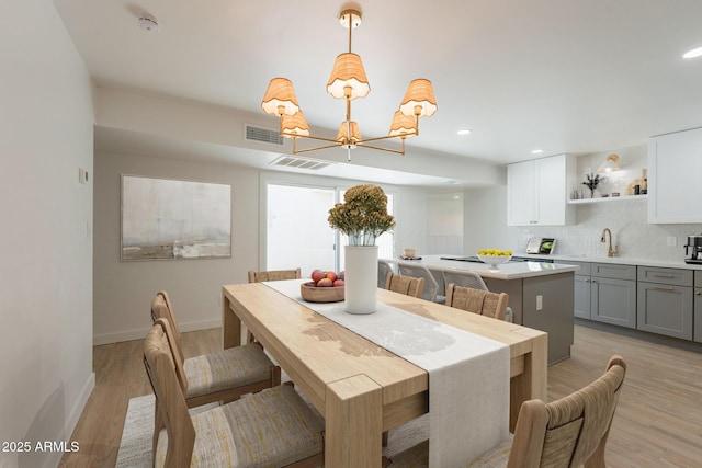 5132 N 83rd St, Scottsdale, AZ 85250 - dining area featuring a chandelier, baseboards, light wood-style floors, and recessed lighting