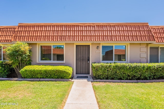 5132 N 83rd St, Scottsdale, AZ 85250 - townhome / multi-family property with mansard roof, a front yard, and brick siding