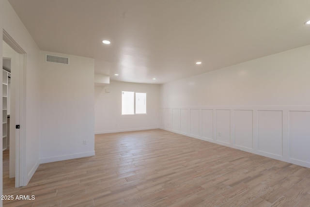 5132 N 83rd St, Scottsdale, AZ 85250 - unfurnished room featuring light wood-type flooring, recessed lighting, a wainscoted wall, and a decorative wall