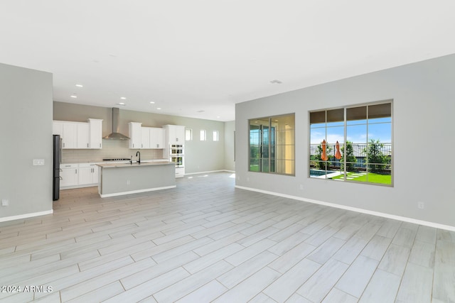 unfurnished living room featuring sink