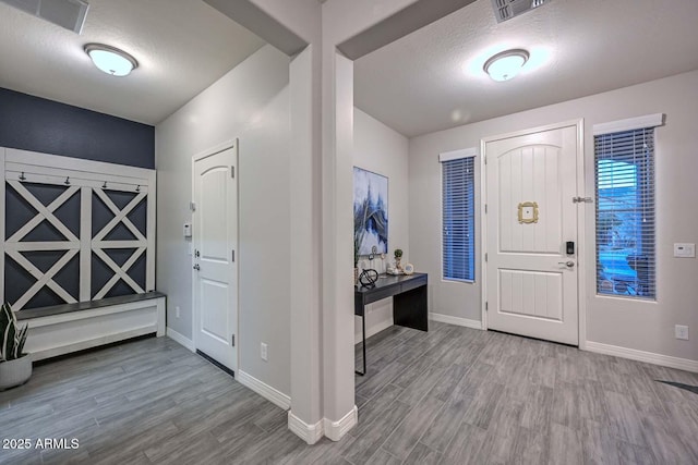 foyer featuring hardwood / wood-style floors and a textured ceiling