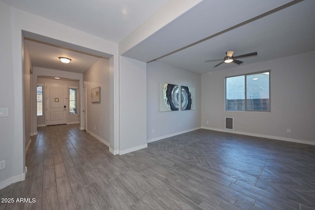 spare room featuring dark wood-type flooring and ceiling fan