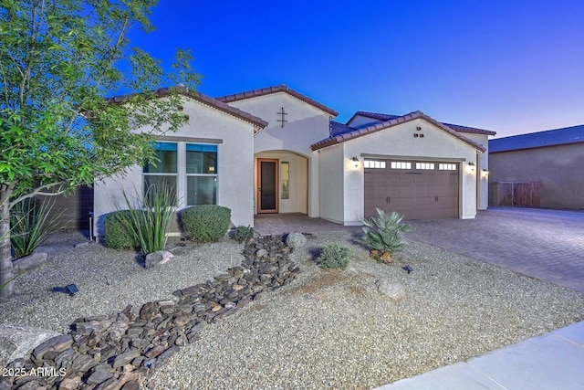 mediterranean / spanish house featuring a garage