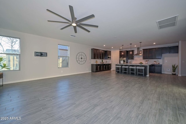 living room with dark wood-type flooring and ceiling fan